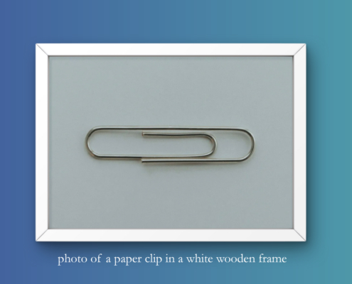 header graphic - photo of a paper clip in a wooden frame with image description - symbolic image for AI-based visual search