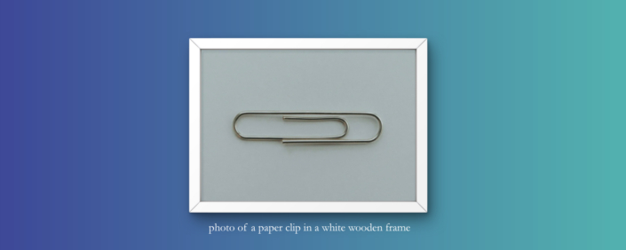 header graphic - photo of a paper clip in a wooden frame with image description - symbolic image for AI-based visual search