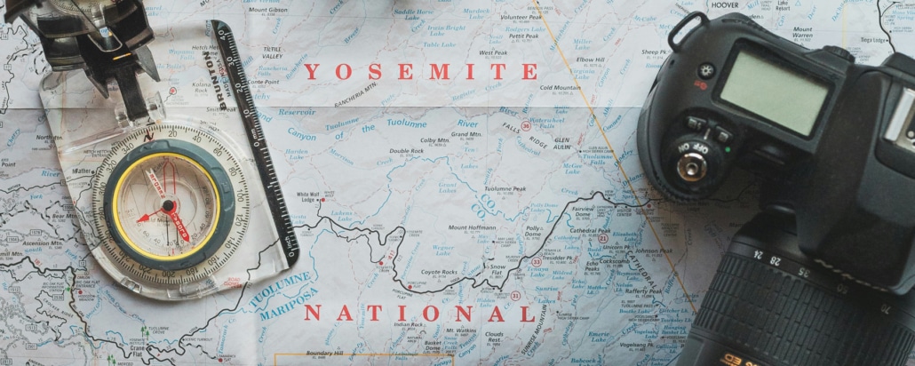 Symbolic image of geodata in media management with compass, map and digital camera